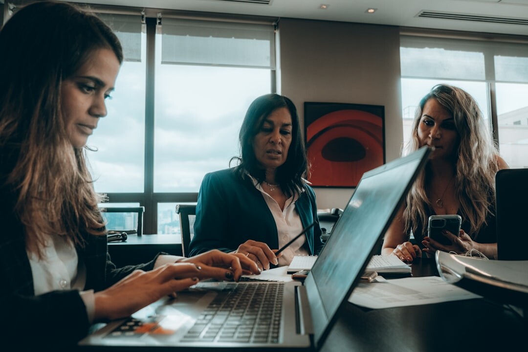 Business people in meeting with documents and laptops