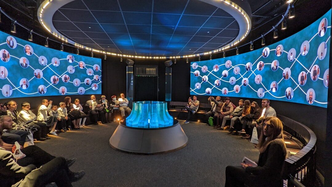 Business conference with presenter on stage in front of large screen